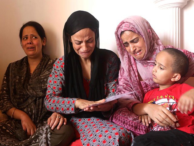 in this photo taken on september 7 2019 shaheena 2nd l the mother of 17 year old asrar khan cries with relatives as they look at picture of the youth who she says died on september 3 a month after being fired upon and seriously injured by indian paramilitary soldiers in srinagar photo afp