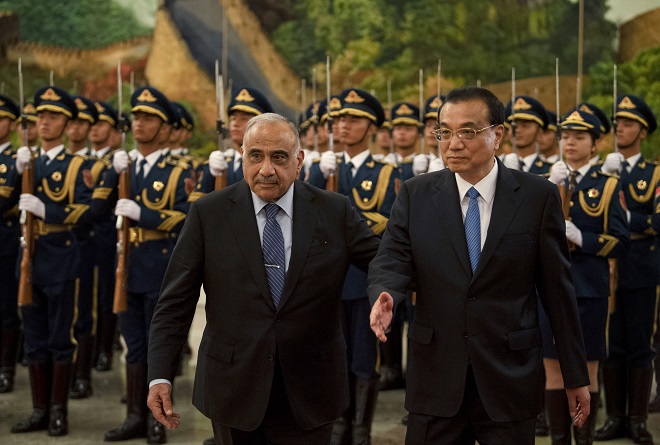 iraqi prime minister adel abdel mahdi front r inspects honour guards with chinese premier li keqiang during a ceremony in beijing photo afp