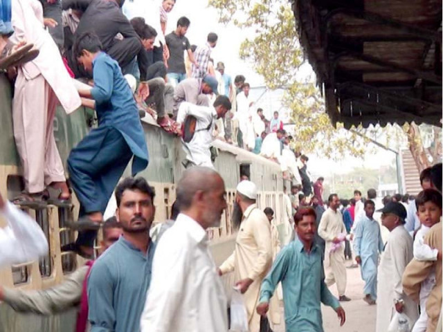 frequent travellers risk their lives by sitting on the roof of compartments due to shortage of bogies photo file frequent travellers risk their lives by sitting on the roof of compartments due to shortage of bogies photo file
