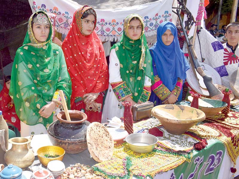 girls in traditional dresses set up stalls at the event photo inp