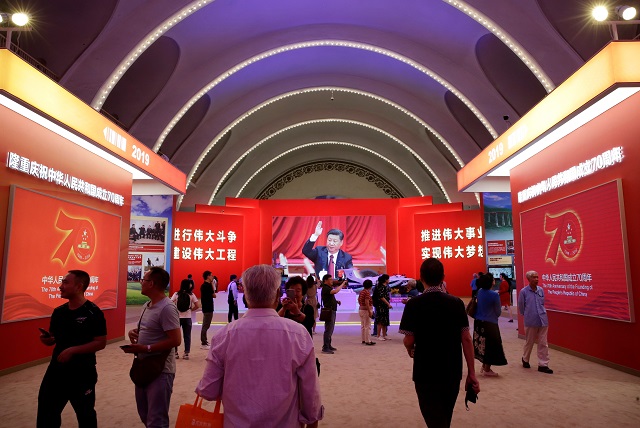 visitors are seen in front of a screen showing chinese president xi jinping at an exhibition on china 039 s achievements marking the 70th anniversary of the founding of the people 039 s republic of china prc at the beijing exhibition center in beijing china photo reuters