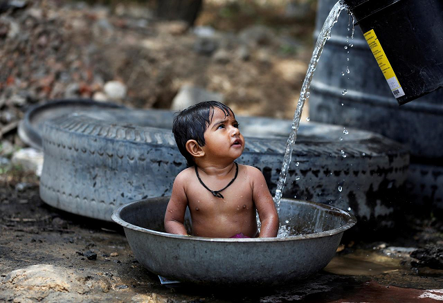 a baby girl cools off as her mother not pictured fills the tub with water on a hot summer day outside a farm on the outskirts of ahmedabad india may 2 2017 photo reuters a baby girl cools off as her mother not pictured fills the tub with water on a hot summer day outside a farm on the outskirts of ahmedabad india may 2 2017 photo reuters