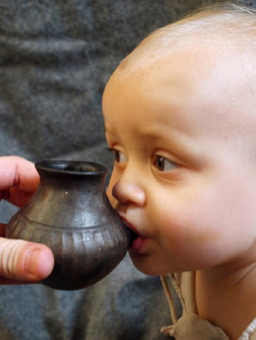a baby is shown feeding from a reconstructed infant feeding vessel of the type investigated in research detailing prehistoric ceramic vessels that functioned as baby bottles in this image released on september 25 2019 photo reuters