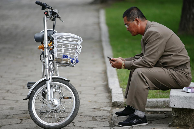 a man uses his mobile phone next to an electric bicycle in downtown pyongyang north korea october 8 2015 photo reuters