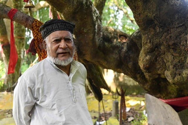 muslim caretaker motibar rahman 73 standing by a shrine to the hindu deity shiva photo afp muslim caretaker motibar rahman 73 standing by a shrine to the hindu deity shiva photo afp