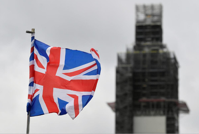 a union jack flag flutters as big ben clock tower is seen behind at the houses of parliament in london photo reuters