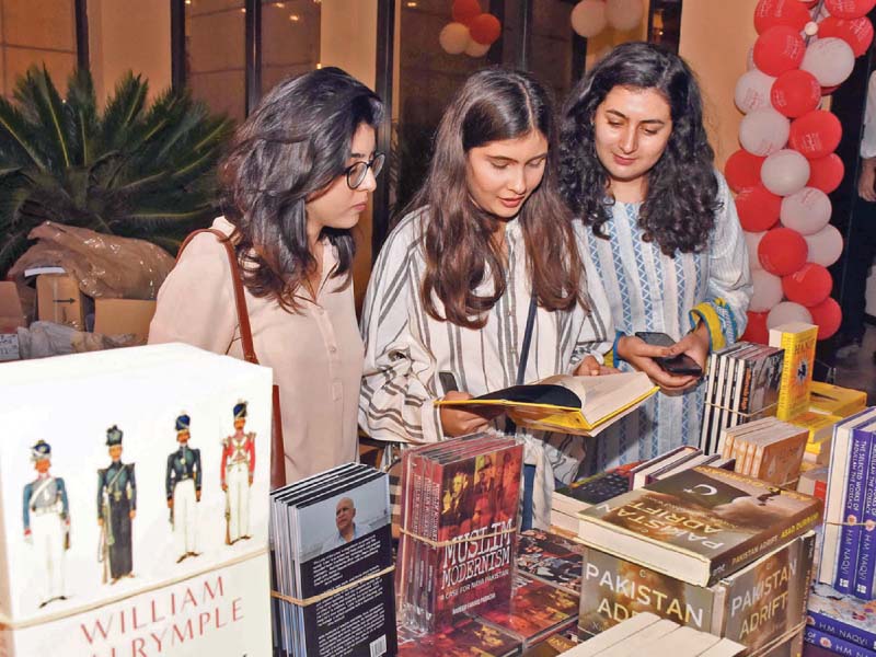 women browse through books at the islamabad literature festival on friday photo express