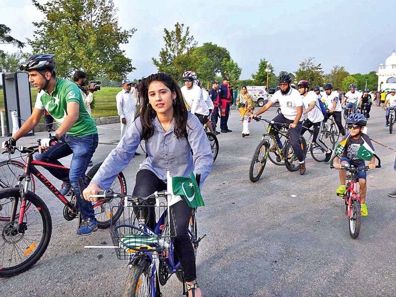 people take part in a bicycle rally on world tourism day at f 9 park photo app