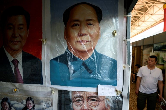 paintings of china 039 s president xi jinping and founder of the people 039 s republic mao zedong adorn the panjiayuan antique market in beijing photo afp