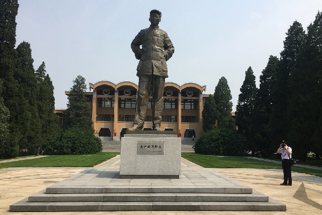 a journalist takes pictures next to a statue of late chinese chairman mao zedong inside the party school of the chinese communist party s central committee during a government organised visit in beijing photo reuters