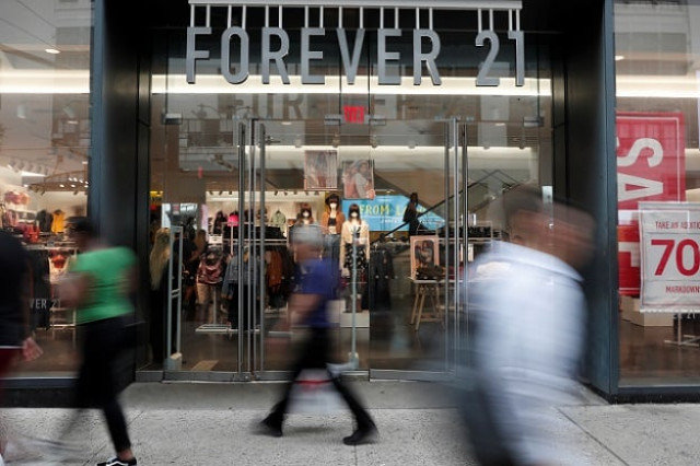 people walk by the clothing retailer forever 21 in new york city united states photo reuters people walk by the clothing retailer forever 21 in new york city united states photo reuters