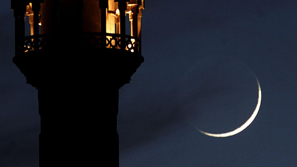 a crescent moon rises close to an illuminated minaret of mosque in amman photo reuters