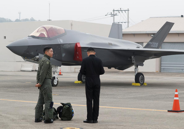 a south korean fighter pilot l stands next to his f 35 stealth fighter during a ceremony to mark the 71st armed forces day at the air force base in daegu south korea photo reuters