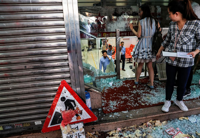 employees of china travel service a tourism and travel agency of the china government are seen at their vandalized office in tsuen wan hong kong china photo reuters employees of china travel service a tourism and travel agency of the china government are seen at their vandalized office in tsuen wan hong kong china photo reuters