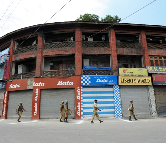 indian paramilitary troops patrol during a strike in srinagar iok photo afp