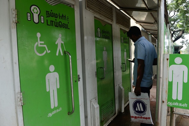 a man waits to use a public toilet on a street in india s chennai photo afp