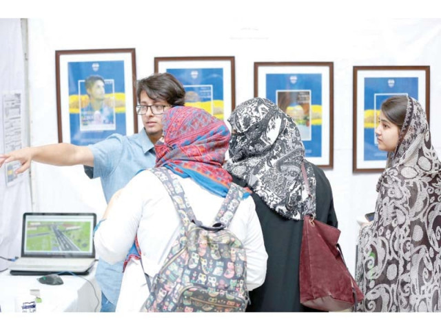 a student explains his artwork to visitors at uop photo express a student explains his artwork to visitors at uop photo express