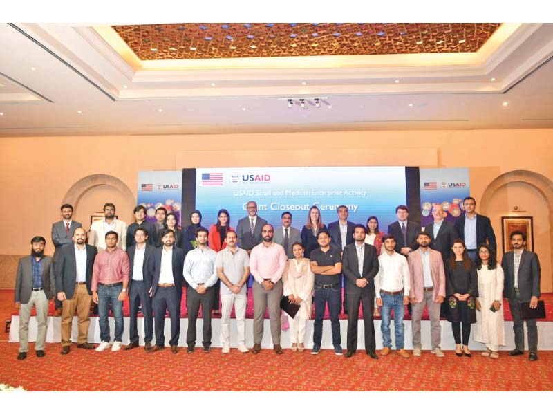 challenge fund grant recipients stand along with usaid mission director julie koenen at the grants closing ceremony held in islamabad photo express