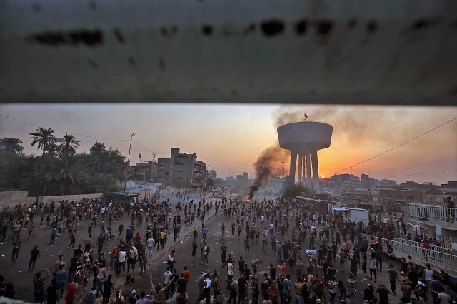 iraqi protesters gather during a demonstration against state corruption failing public services and unemployment at tayaran square in baghdad photo afp