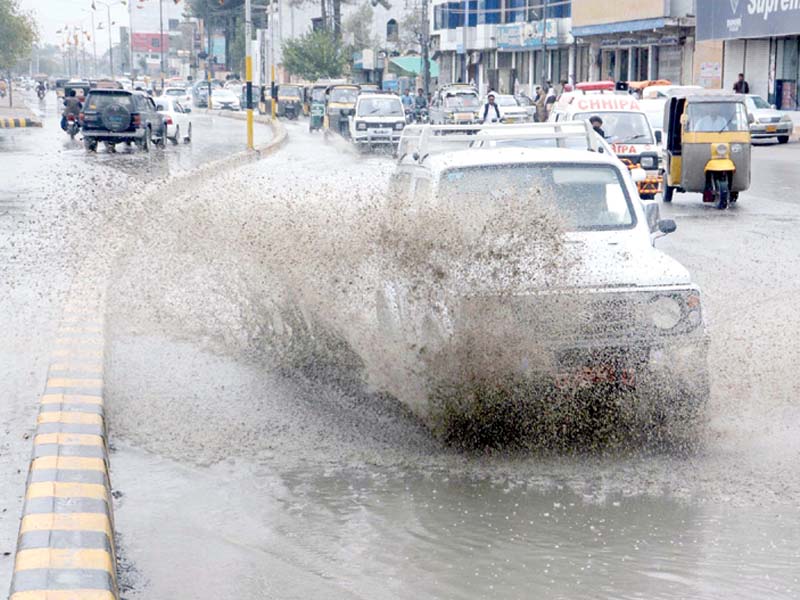 vehicles pass through an inundated road in quetta photo ppi