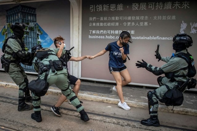 police chased down a couple wearing facemasks in the central district in hong kong photo afp