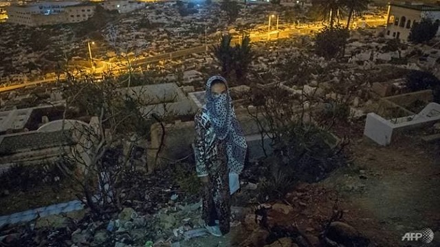 a moroccan addict stands in a cemetery overlooking tetouan a common spot for drug users photo afp