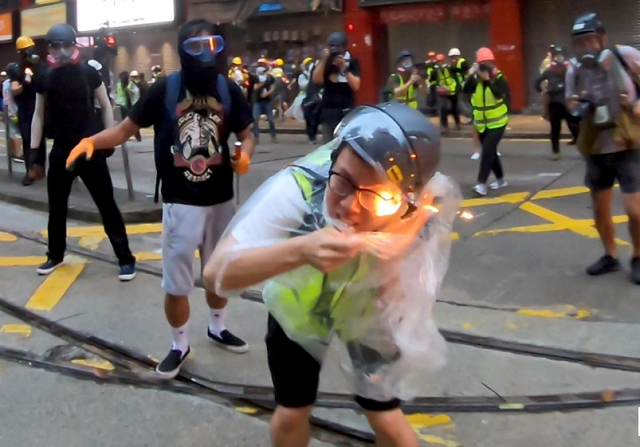 flames are seen on a journalist after he was hit with a petrol bomb during a protest in wan chai hong kong china photo reuters flames are seen on a journalist after he was hit with a petrol bomb during a protest in wan chai hong kong china photo reuters