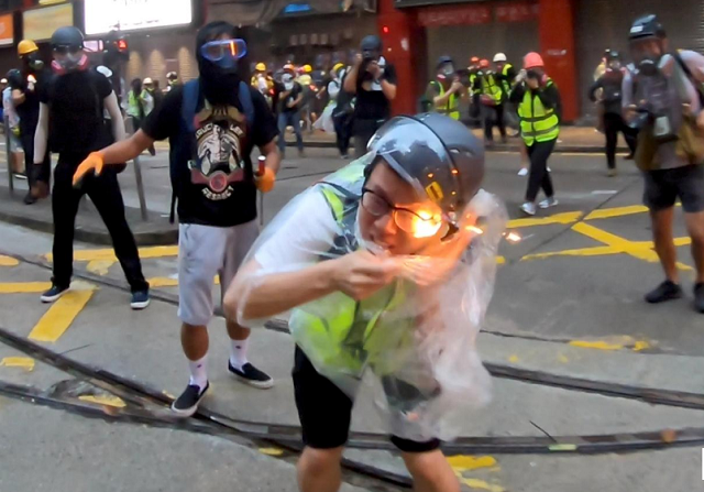 flames are seen on a journalist after he was hit with a petrol bomb during a protest in wan chai hong kong china photo reuters