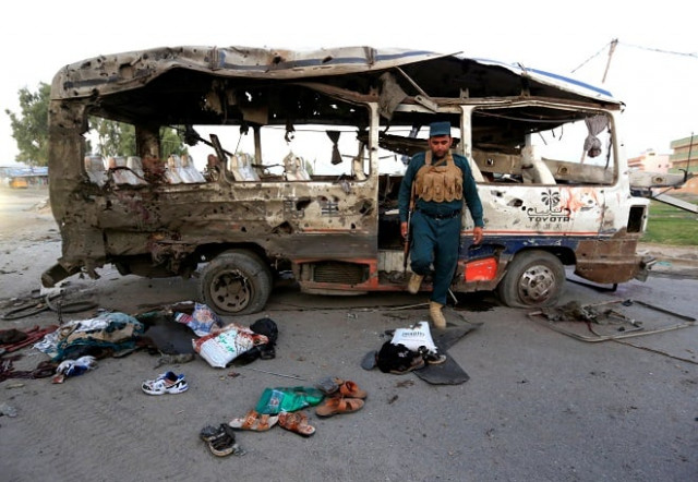 an afghan policeman inspects a damaged minibus after a blast in jalalabad afghanistan photo reuters an afghan policeman inspects a damaged minibus after a blast in jalalabad afghanistan photo reuters