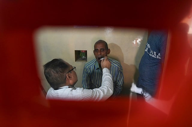 in this photograph a doctor checks a suspected tuberculosis tb patient at a dots directly observed treatment short course centre in new delhi india photo afp in this photograph a doctor checks a suspected tuberculosis tb patient at a dots directly observed treatment short course centre in new delhi india photo afp