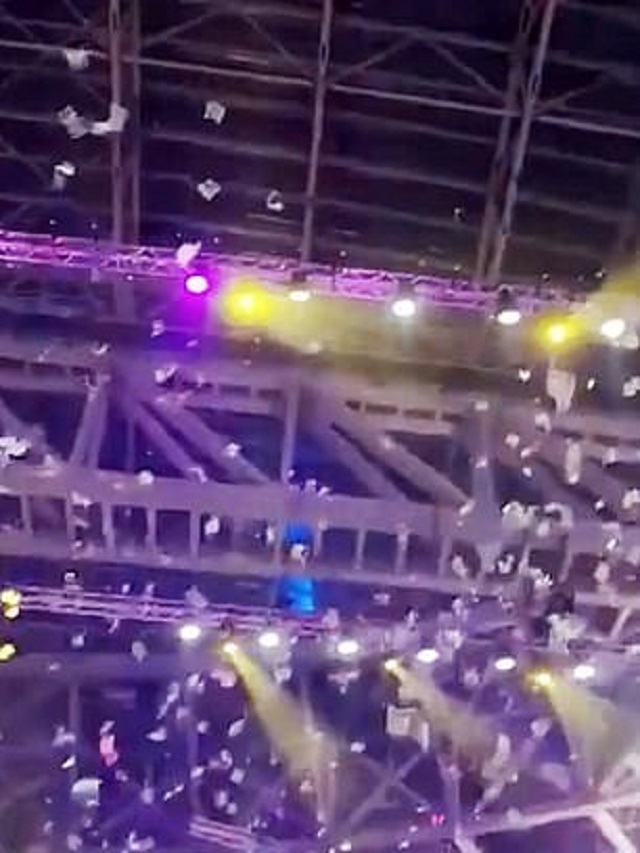russian tycoon releases rain shower of dollar bills into audience