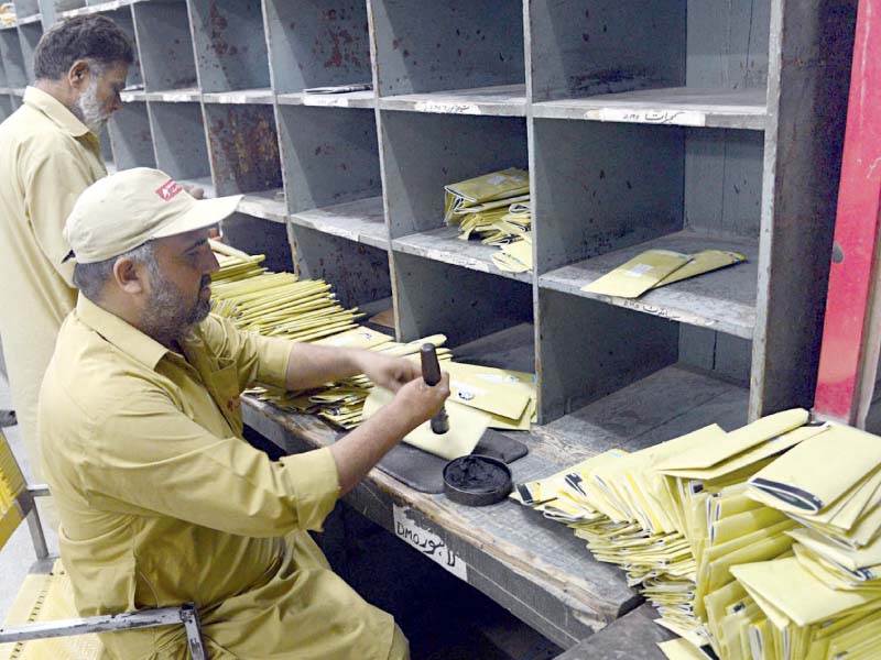 workers sort mail at a post office in lahore photo online