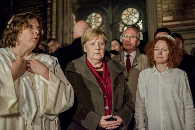 german chancellor angela merkel met rabbi gesa ederberg l and other members of the jewish community at a vigil outside the new synagogue in berlin photo afp german chancellor angela merkel met rabbi gesa ederberg l and other members of the jewish community at a vigil outside the new synagogue in berlin photo afp