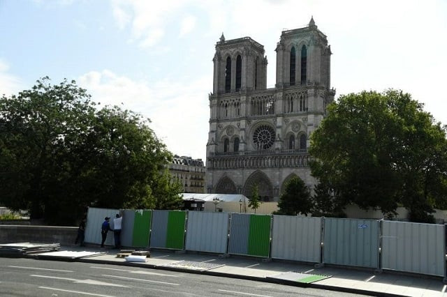 workers installed fencing around notre dame cathedral in august as they began lead clean up operations photo afp workers installed fencing around notre dame cathedral in august as they began lead clean up operations photo afp