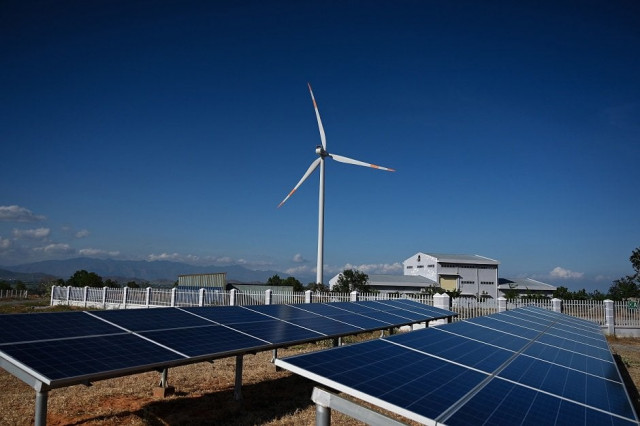solar panel installations and a wind turbine at the phu lac wind farm in southern vietnam 039 s binh thuan province photo afp solar panel installations and a wind turbine at the phu lac wind farm in southern vietnam 039 s binh thuan province photo afp