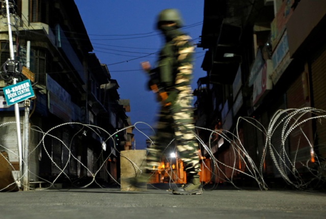 an indian security force personnel stands guard in a street n srinagar photo reuters