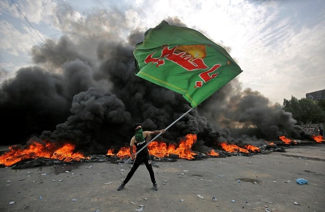 file photo of an iraqi protester waving an iraqi hezbollah flag during a demonstration against state corruption failing public services and unemployment in the baladiyat district of the capital baghdad photo afp file photo of an iraqi protester waving an iraqi hezbollah flag during a demonstration against state corruption failing public services and unemployment in the baladiyat district of the capital baghdad photo afp