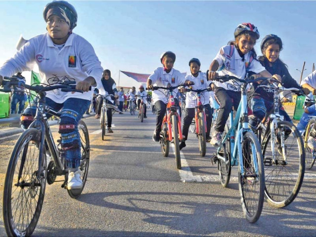 girls participate in a bicycle race near do darya organised by lyari girls cafe to celebrate the international day of the girl child photos online inp