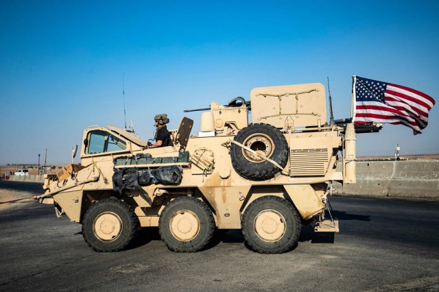 a us military vehicle patrols a road near the town of tal baydar in the countryside of syria photo afp