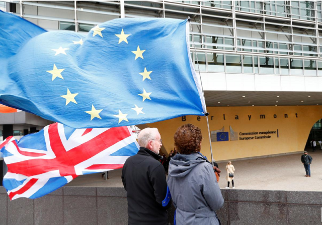 anti brexit protesters hold british and european union flags outside the eu commission headquarters in brussels belgium photo reuters anti brexit protesters hold british and european union flags outside the eu commission headquarters in brussels belgium photo reuters