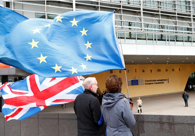 anti brexit protesters hold british and european union flags outside the eu commission headquarters in brussels belgium photo reuters