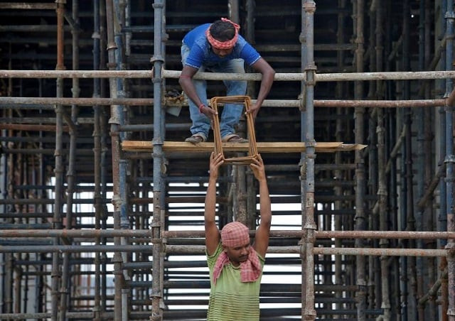 labourers work at the construction site of a residential building on the outskirts of kolkata india july 5 2019 photo reuters labourers work at the construction site of a residential building on the outskirts of kolkata india july 5 2019 photo reuters
