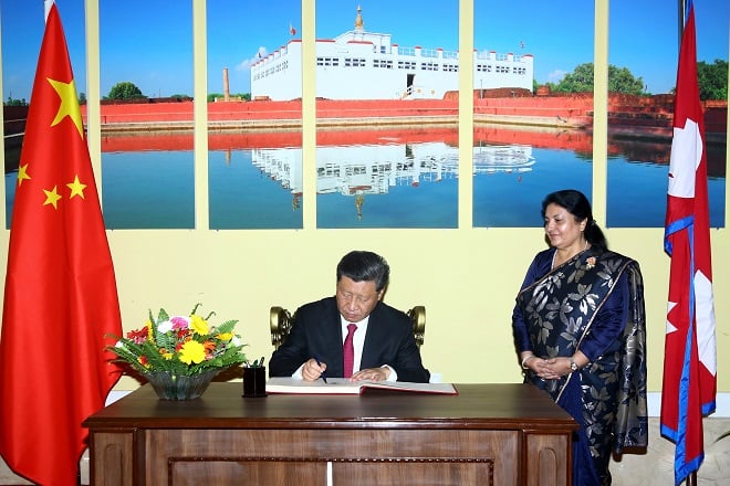 china 039 s president xi jinping l on oct 12 signs a book as nepal 039 s president bidhya devi bhandari looks on photo afp