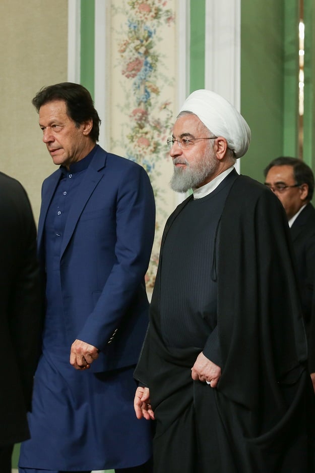 iranian president hassan rouhani walks with pakistani prime minister imran khan as they attend a press conference in tehran photo reuters