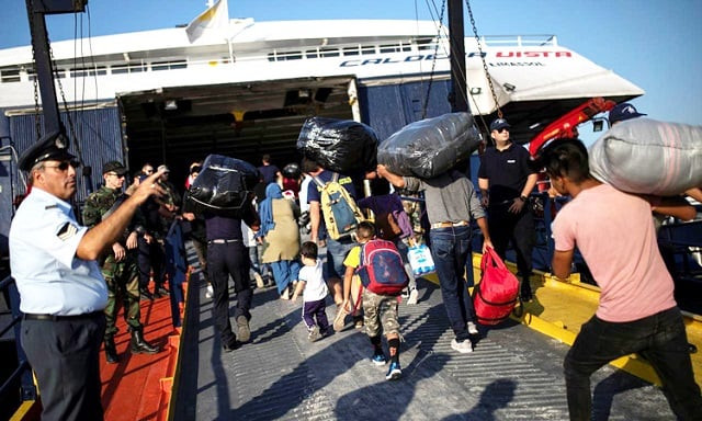 migrants from afghanistan board a catamaran that will transfer them to the mainland in mytilene on the island of lesbos greece photo reuters file migrants from afghanistan board a catamaran that will transfer them to the mainland in mytilene on the island of lesbos greece photo reuters file