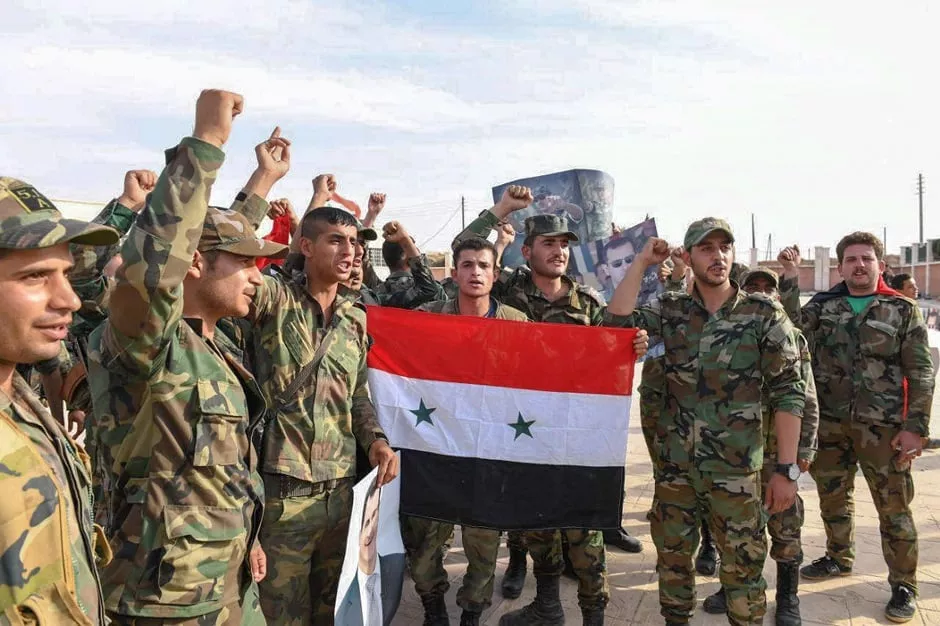 syrian army troops posing with a national flag photo afp