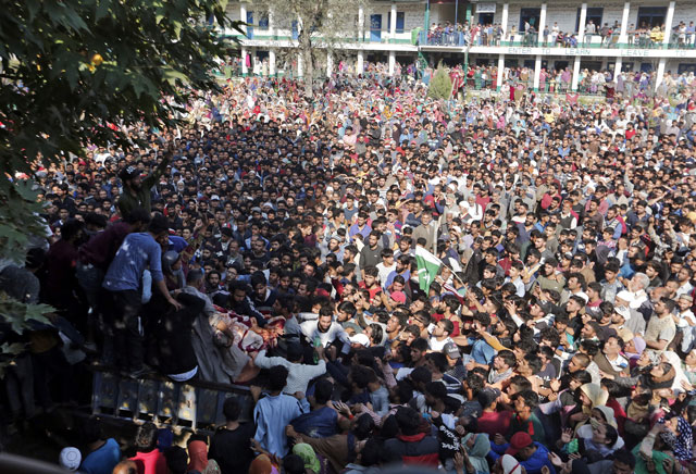 kashmiri men gather around the body of nasir ahmad a freedom fighter during his funeral in iok s anantnag district on wednesday photo reuters