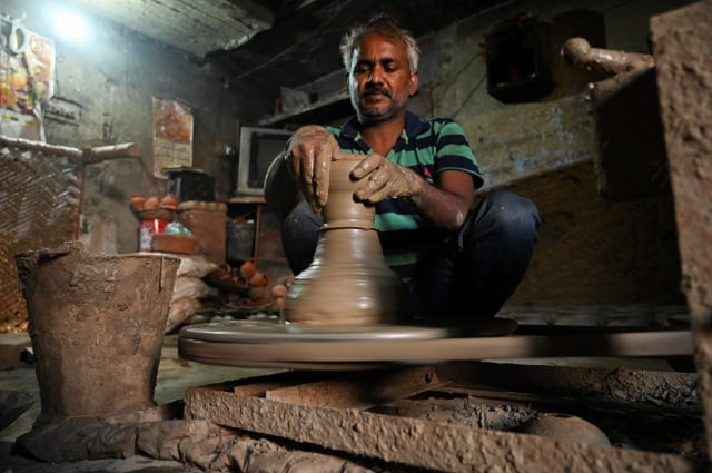 a potter makes a clay pot in his residence at kumhar gram potter 039 s village in new delhi photo afp a potter makes a clay pot in his residence at kumhar gram potter 039 s village in new delhi photo afp