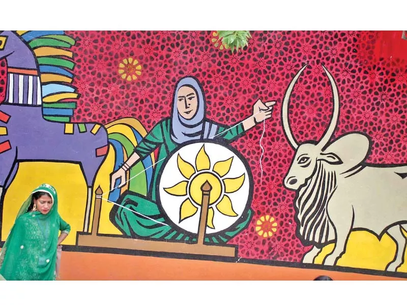 a rural woman walks past a mural at lok virsa on the last day of annual conference of rural women day organised by the potohar organisation for development advocacy photo online a rural woman walks past a mural at lok virsa on the last day of annual conference of rural women day organised by the potohar organisation for development advocacy photo online