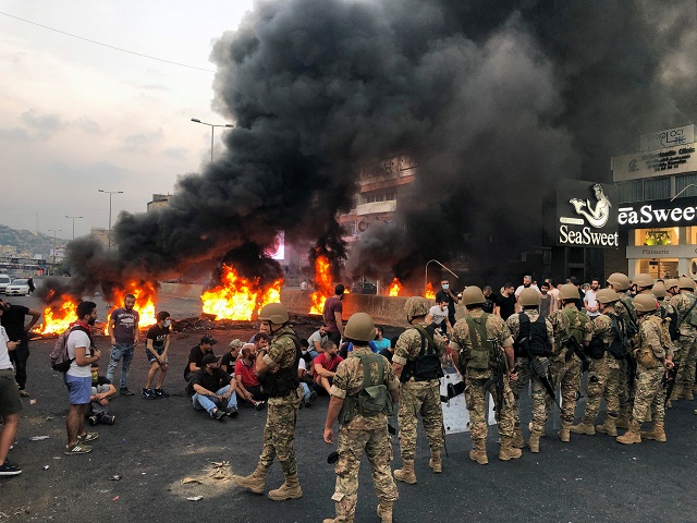 demonstrators sit together during a protest over deteriorating economic situation in the city of jounieh north of beirut photo reuters